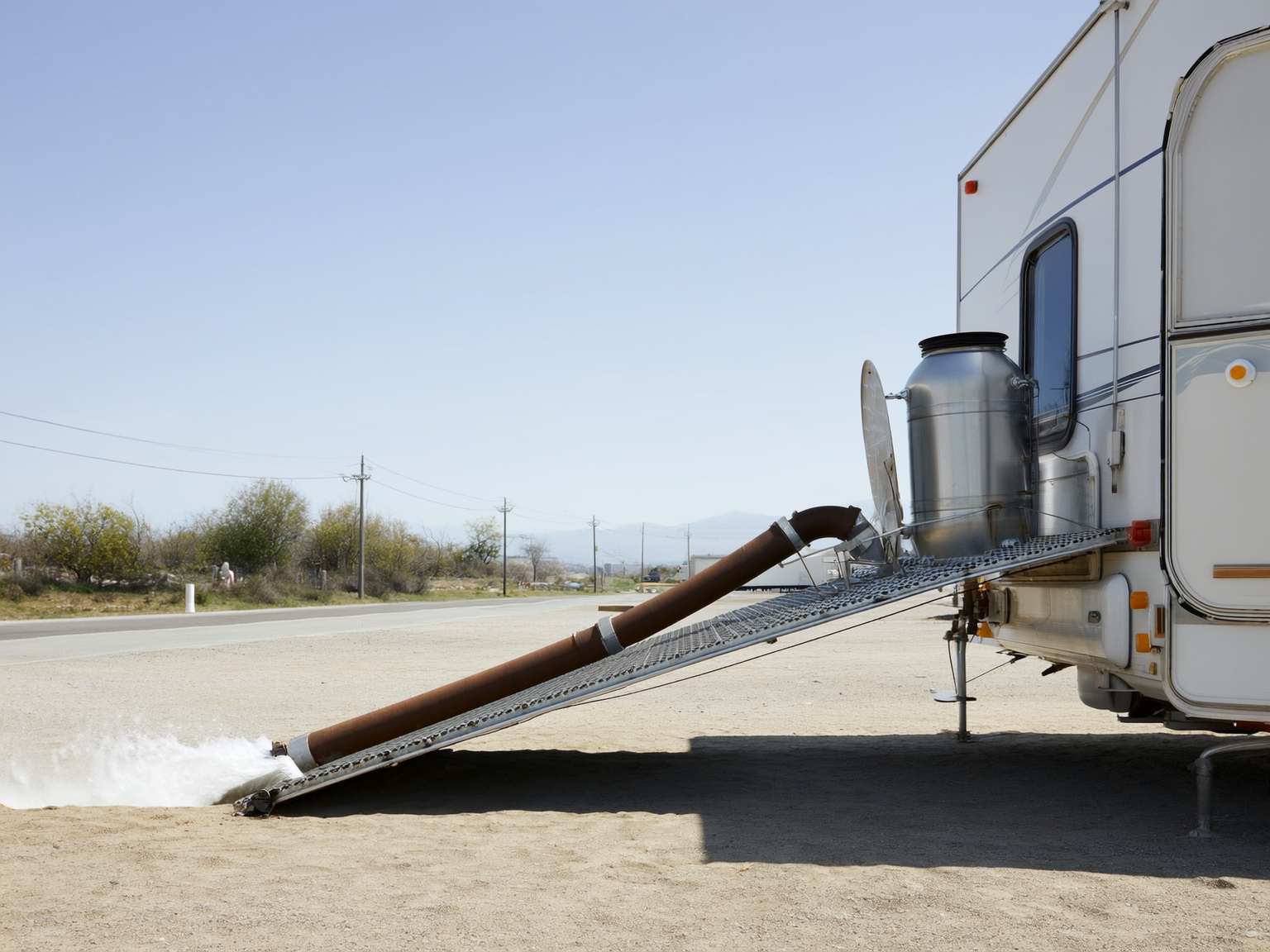 Secure RV sewer hose support system at a full hookup campsite