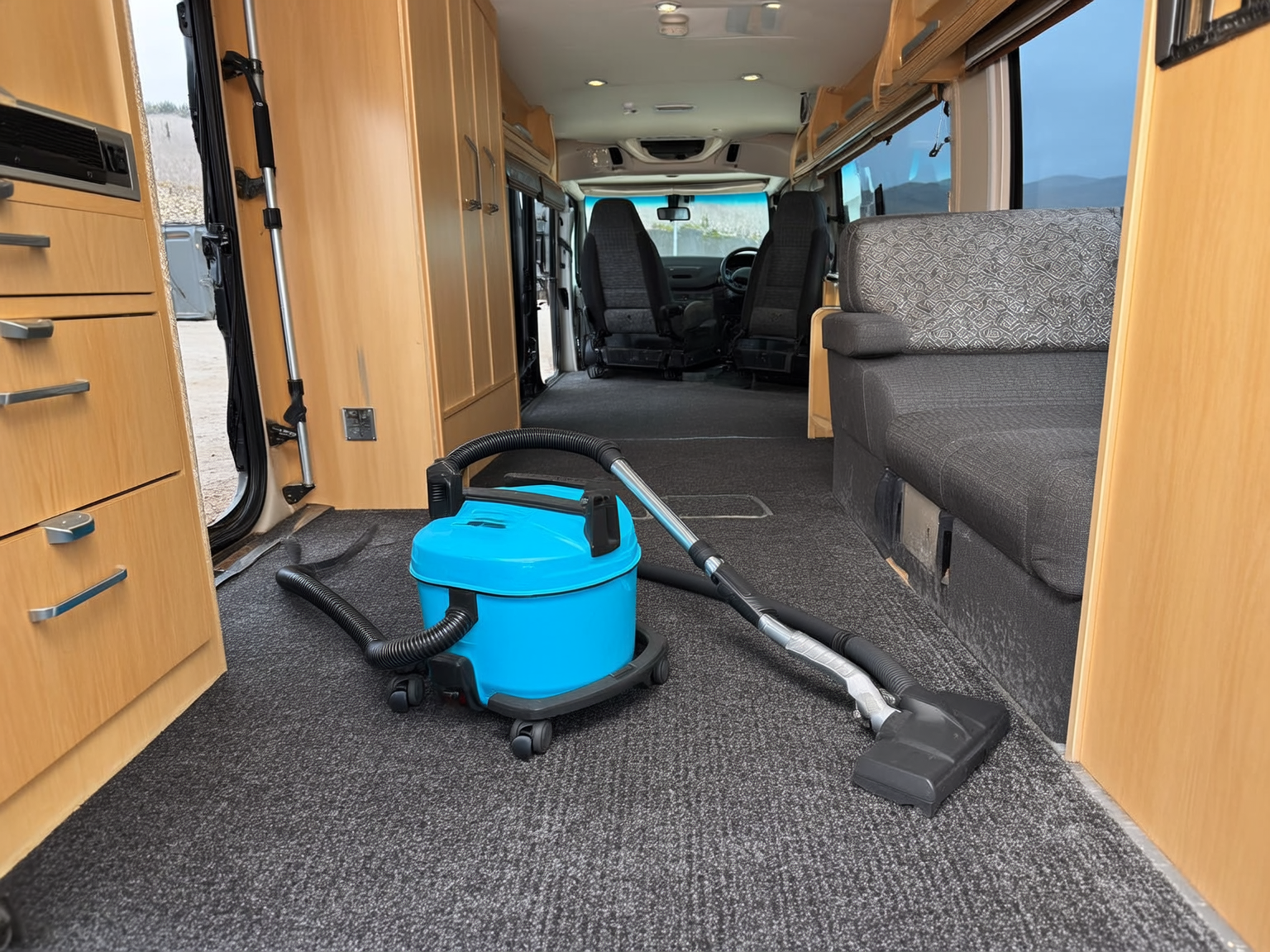 Vacuum cleaning a high traffic carpet path inside an RV during a long stay