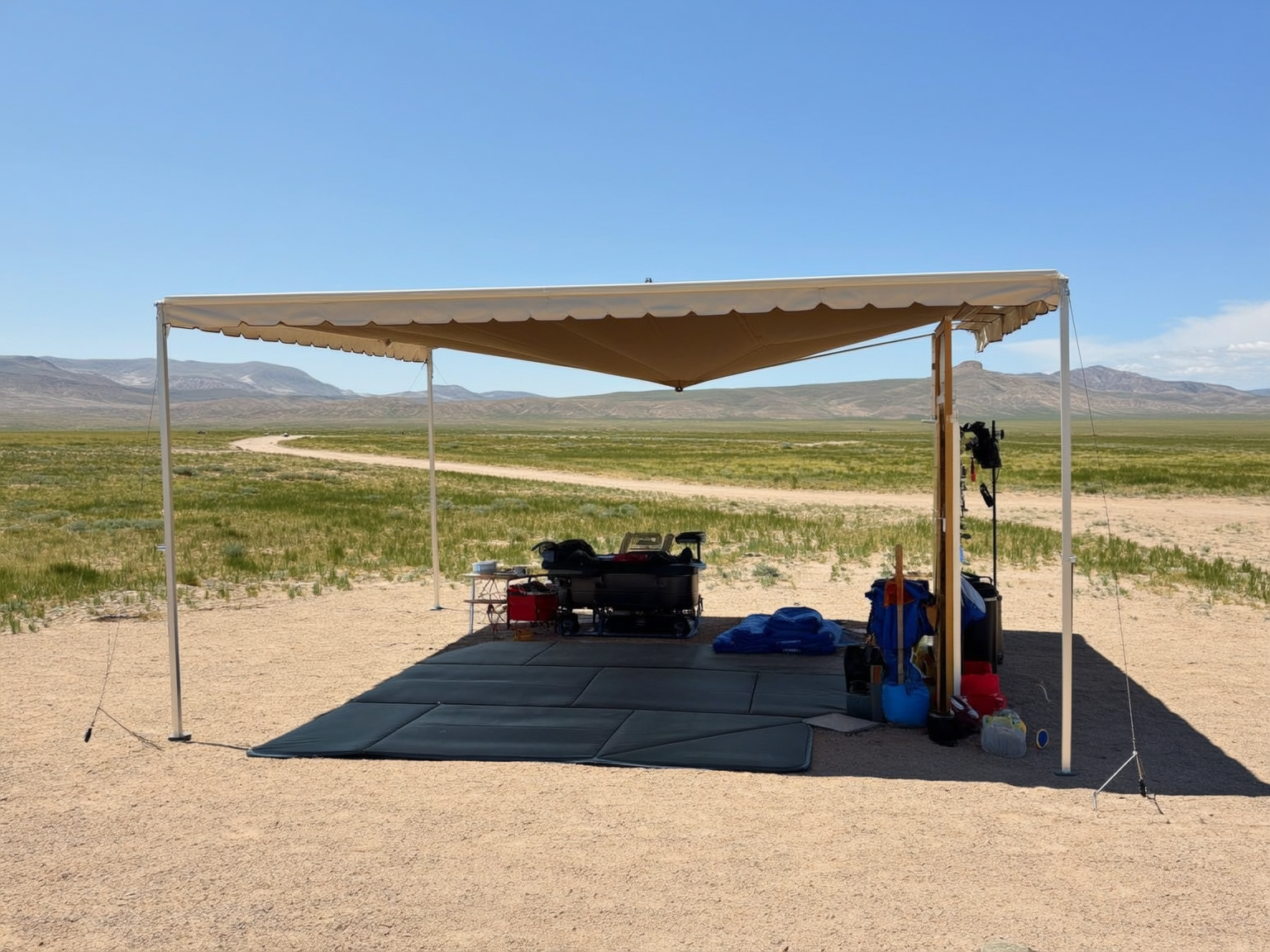 Well-organized RV campsite in Wyoming with shade setup and summer gear