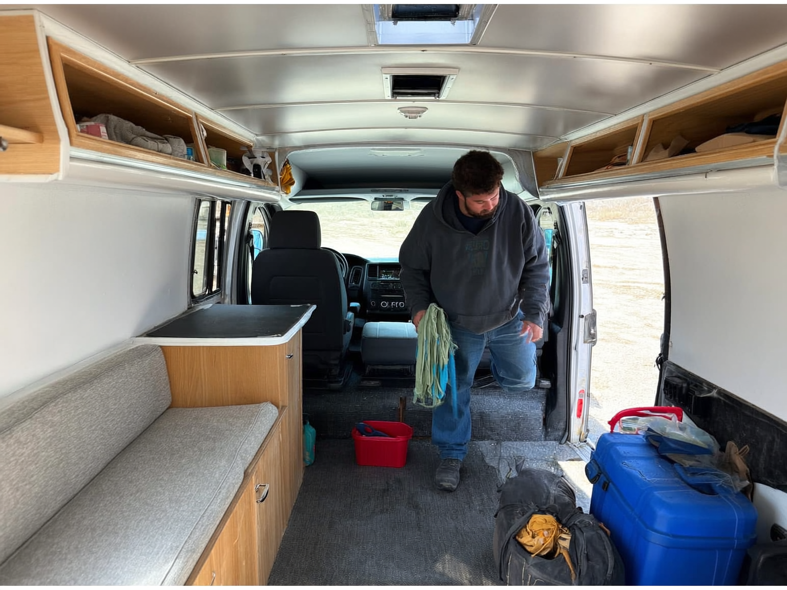 Worker organizing tools and supplies inside a used RV before relocating to Casper