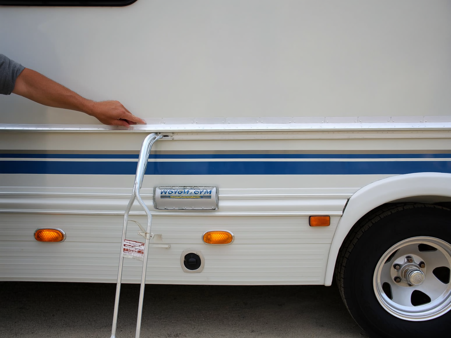 RV owner inspecting front cap seam and roofline before a Wyoming trip