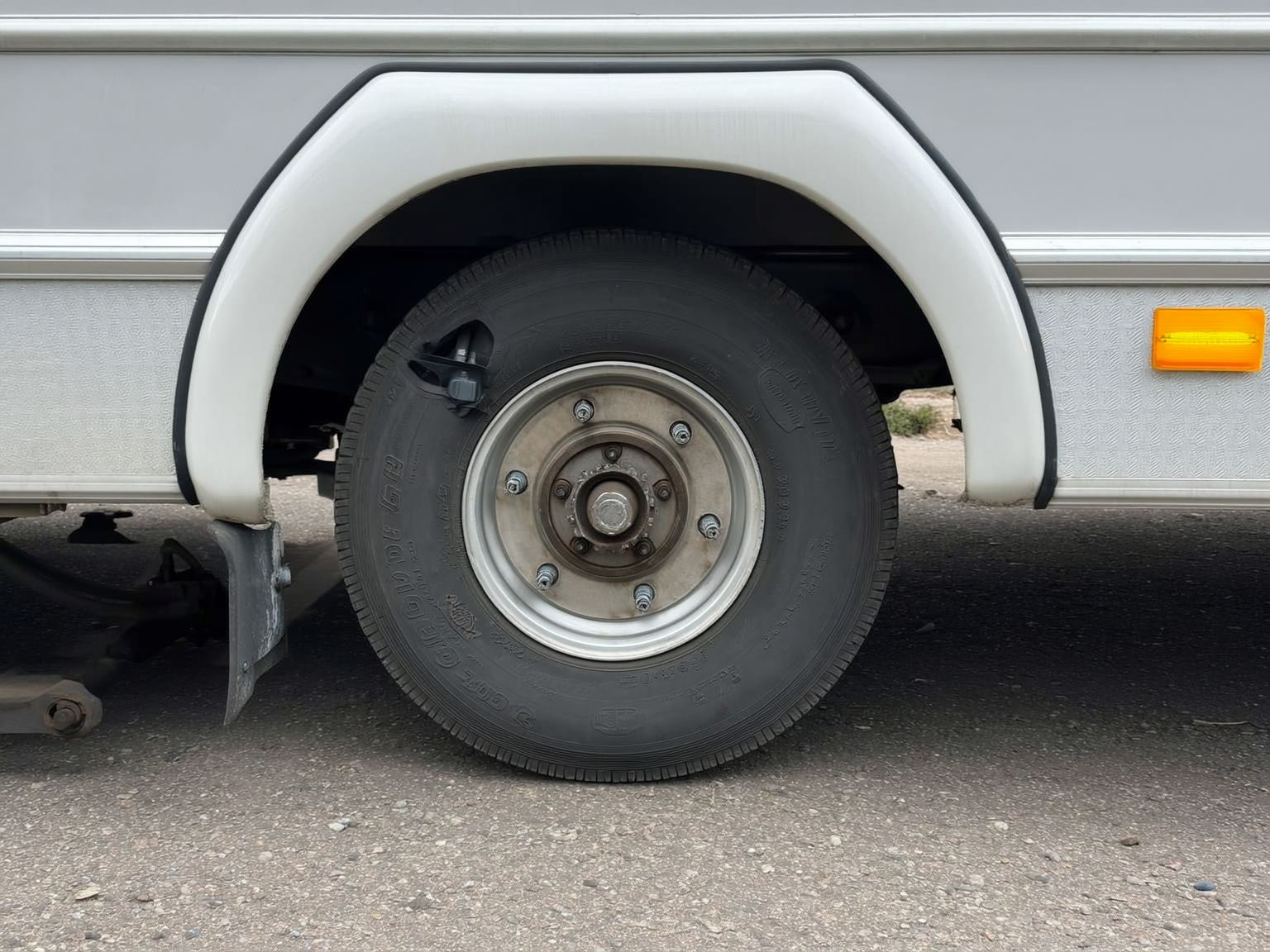 Close-up of RV brake inspection with wheel and brake components visible