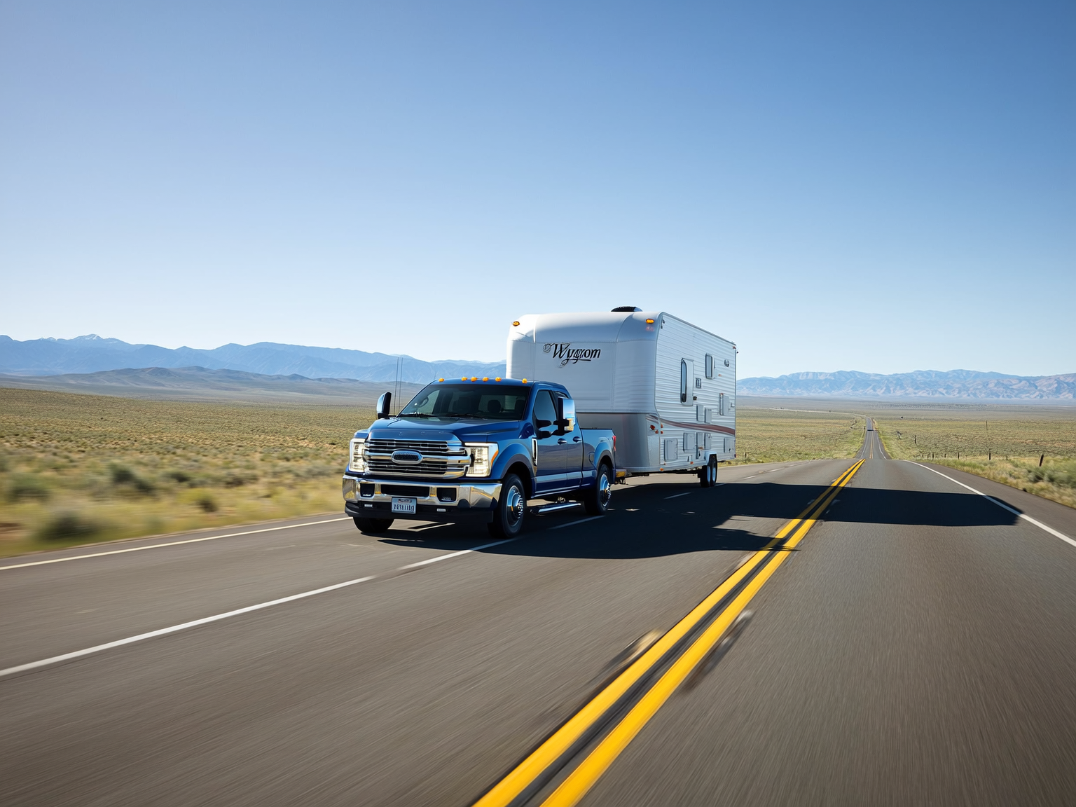 Pickup truck towing a travel trailer through a Wyoming downhill route