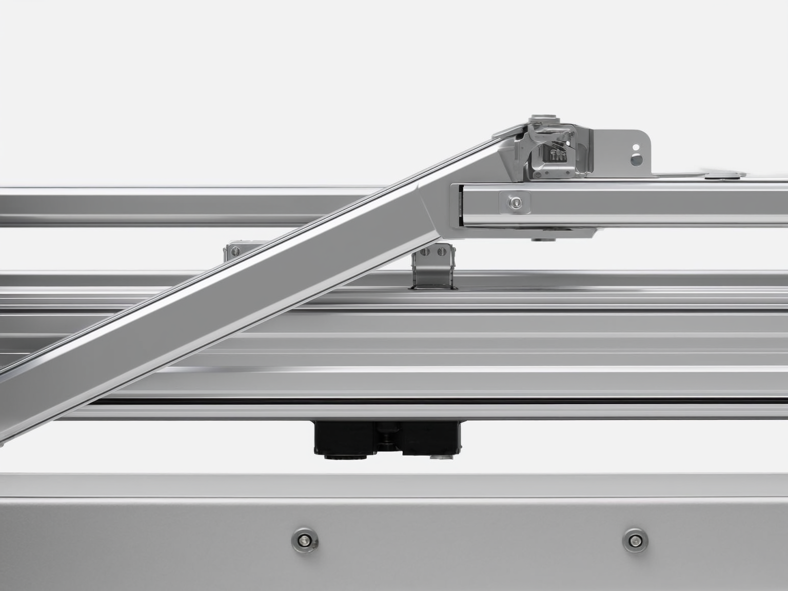 Close-up of an RV slideout mechanism and rail during careful maintenance inspection