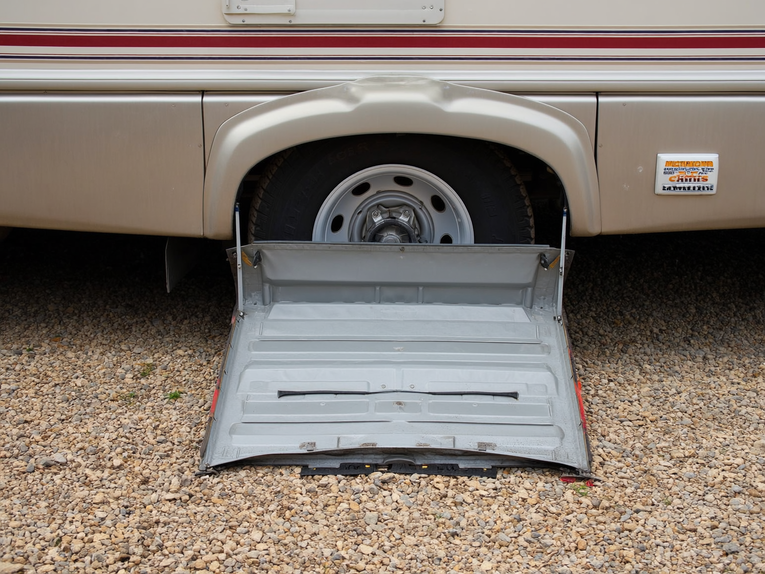 RVer cleaning dust from an RV slide seal before maintenance at a Wyoming campsite